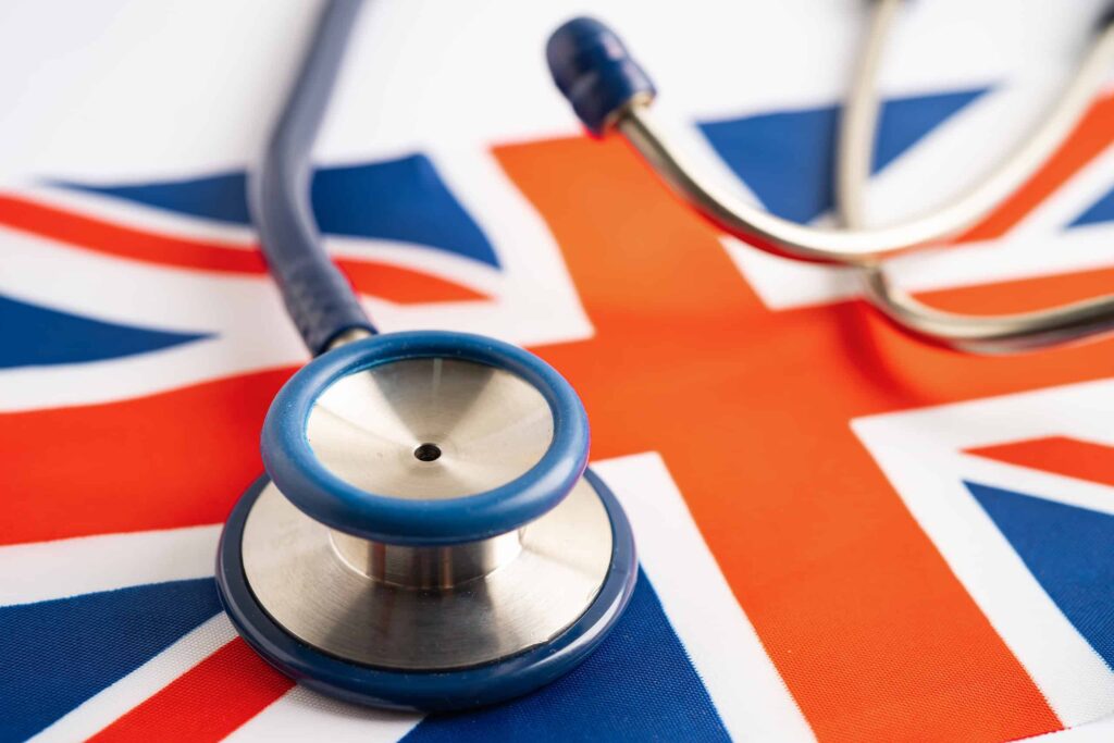 Stethoscope on United Kingdom flag background, Business and finance concept.